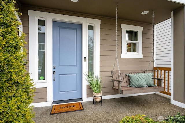 view of exterior entry with a porch