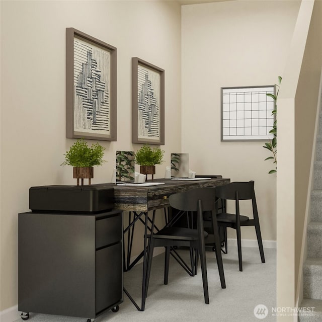 dining area with light carpet, baseboards, and stairs