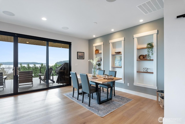 dining area with built in shelves, recessed lighting, visible vents, light wood-style floors, and baseboards