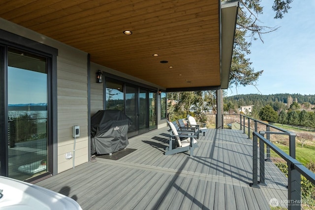 wooden terrace with a grill