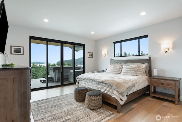 bedroom featuring access to exterior, light wood finished floors, and recessed lighting