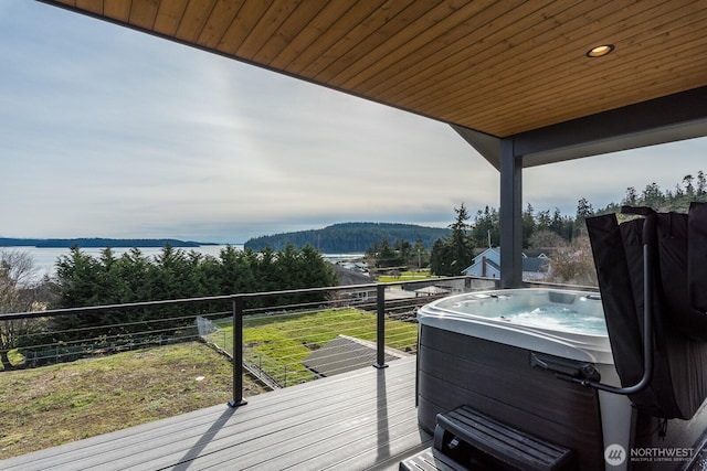 wooden deck featuring a hot tub