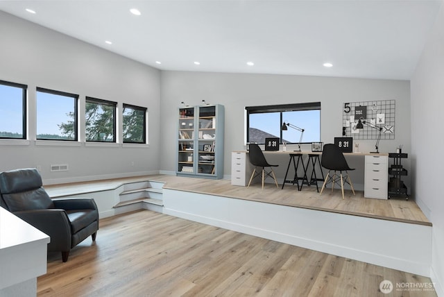 office space with lofted ceiling, wood finished floors, a wealth of natural light, and recessed lighting