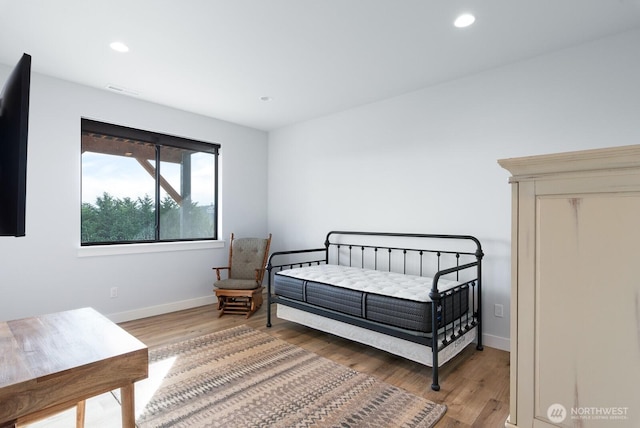 bedroom with recessed lighting, light wood-style flooring, and baseboards