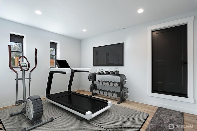 workout area with baseboards, recessed lighting, visible vents, and light wood-style floors