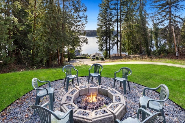 view of patio / terrace featuring a water view and an outdoor fire pit