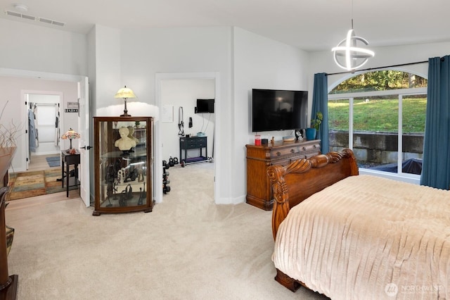 bedroom with an inviting chandelier, baseboards, visible vents, and light colored carpet