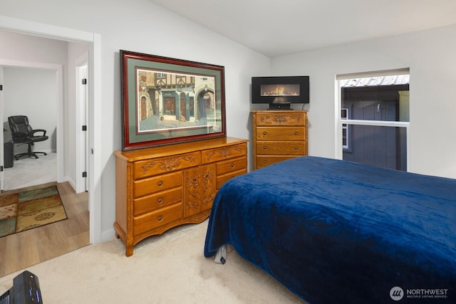 bedroom with carpet floors and vaulted ceiling