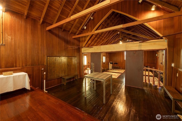miscellaneous room with beamed ceiling, wood walls, wood-type flooring, and wooden ceiling