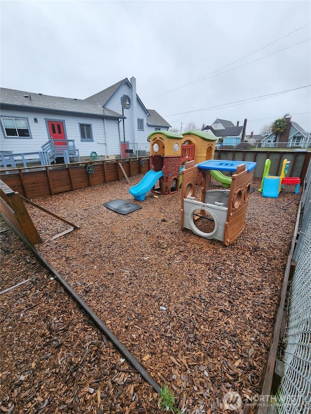 view of jungle gym featuring fence