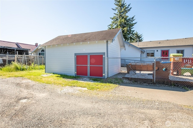 view of outbuilding featuring fence