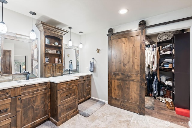 full bathroom with a spacious closet and vanity