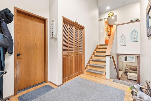 interior space with baseboards, wood finished floors, and stairs