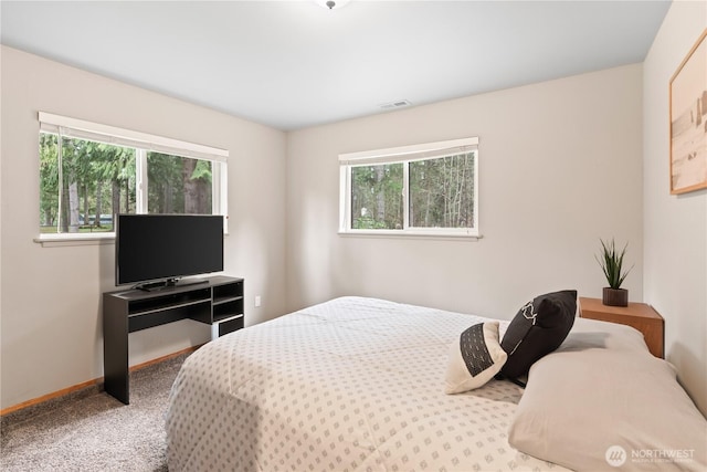 bedroom with carpet flooring, baseboards, and visible vents