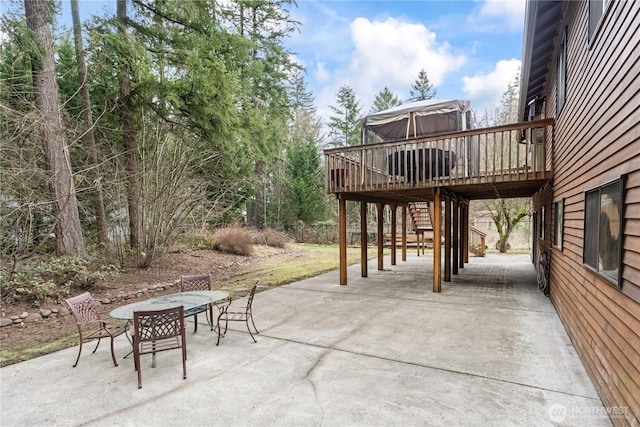 view of patio / terrace featuring outdoor dining space, stairway, and a wooden deck