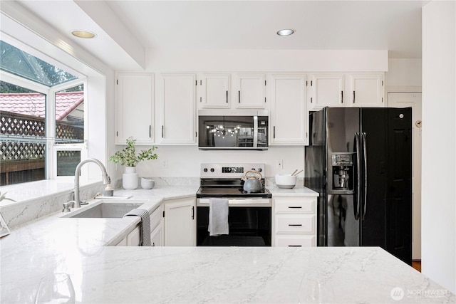 kitchen with white cabinets, light stone countertops, stainless steel electric stove, black refrigerator with ice dispenser, and a sink