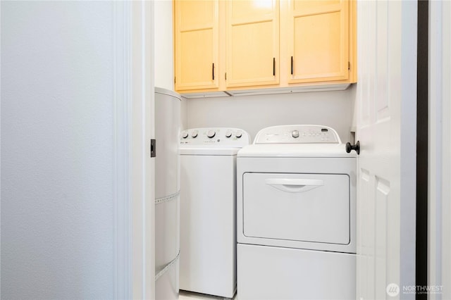 washroom featuring cabinet space and separate washer and dryer