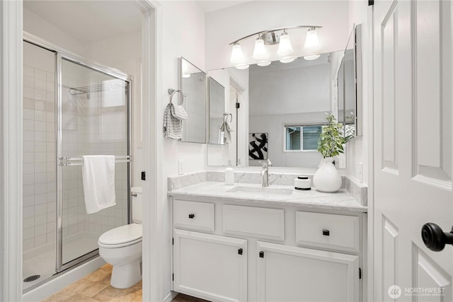 full bathroom with a stall shower, vanity, and toilet