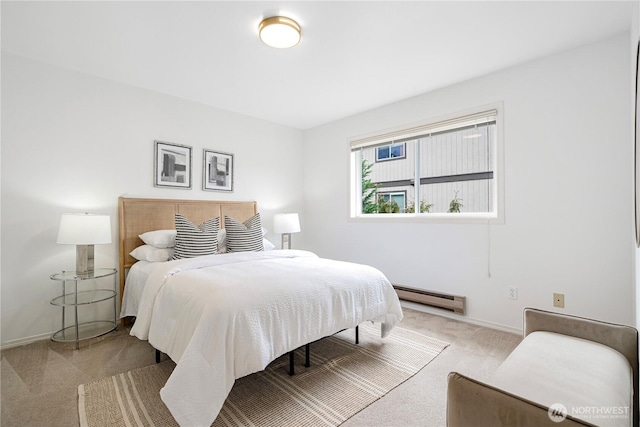 bedroom with baseboards, a baseboard heating unit, and light colored carpet