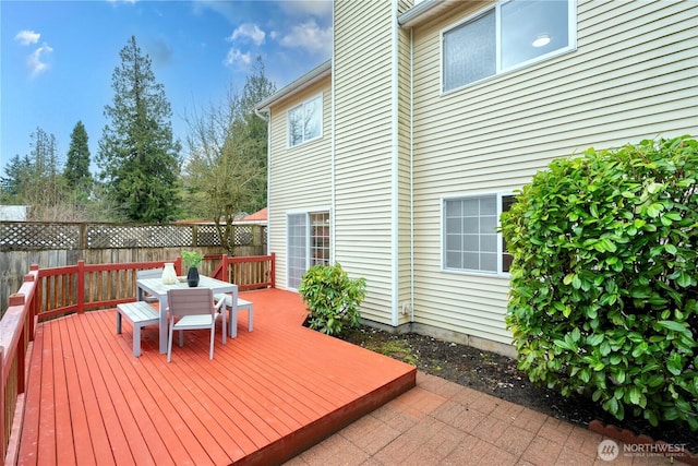 wooden terrace featuring outdoor dining space and fence