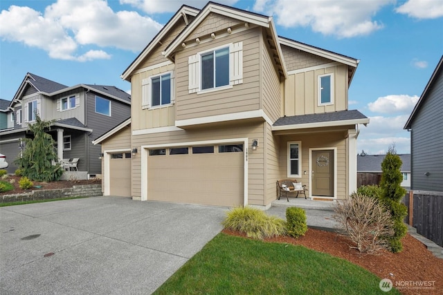 craftsman-style house featuring concrete driveway, a garage, fence, and board and batten siding