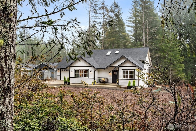 view of front of home featuring roof with shingles