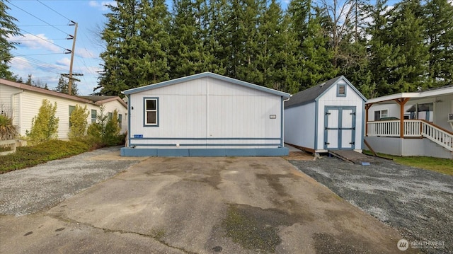 view of front of home featuring an outbuilding and a storage shed