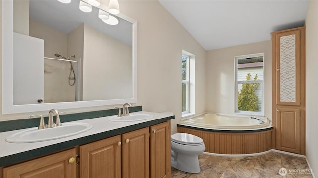 bathroom with vaulted ceiling, a shower with shower door, a sink, and a garden tub