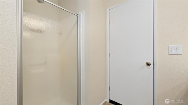 full bathroom featuring a shower stall