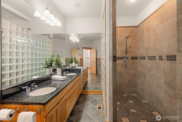 full bathroom with a walk in shower, double vanity, tile patterned flooring, and a sink