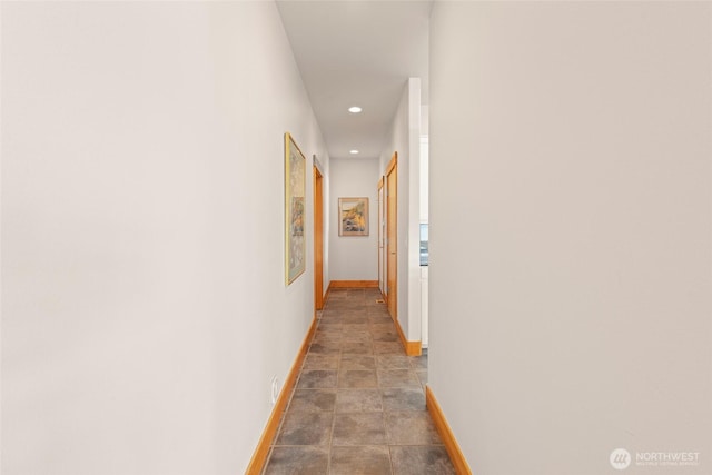 hallway featuring recessed lighting and baseboards