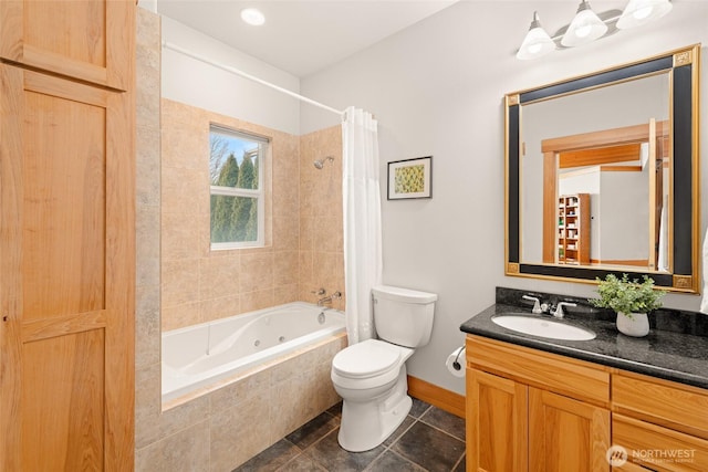 bathroom featuring tile patterned flooring, toilet, vanity, baseboards, and a combined bath / shower with jetted tub