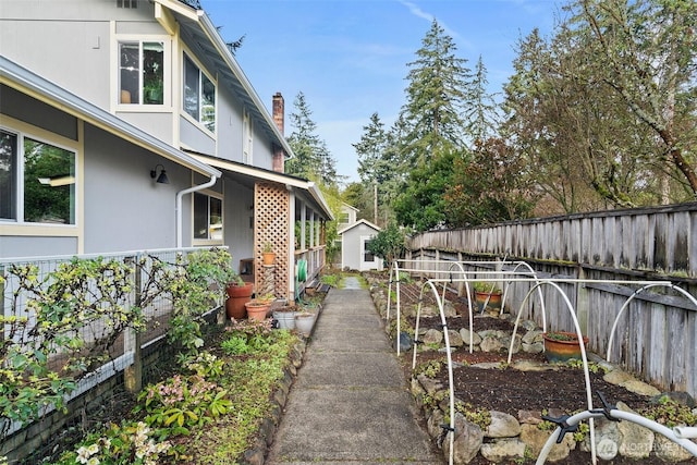 view of yard featuring a vegetable garden and fence