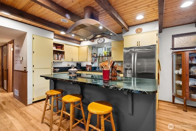 kitchen featuring beamed ceiling, wood ceiling, light wood-style flooring, stainless steel fridge, and open shelves