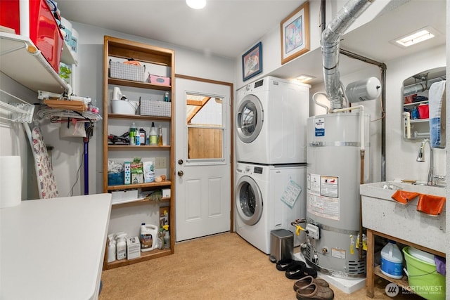 laundry area with strapped water heater, stacked washer / drying machine, and laundry area