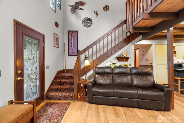 living room with stairs and wood finished floors