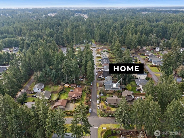 bird's eye view with a wooded view and a residential view