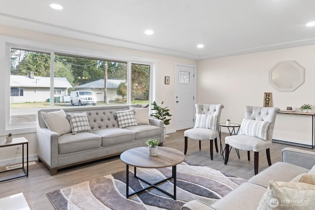 living area with recessed lighting, baseboards, and wood finished floors