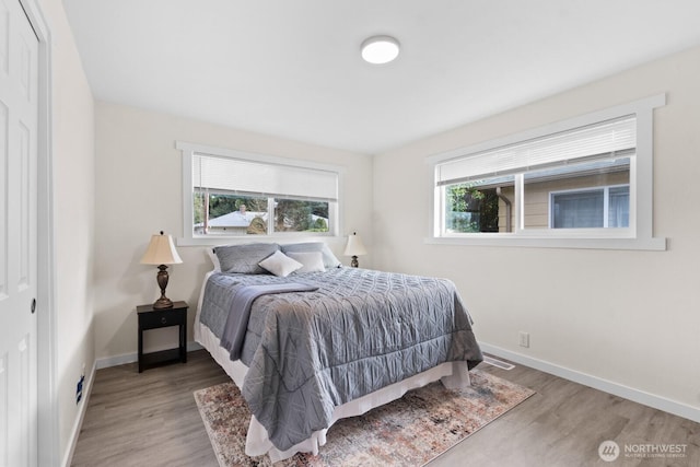 bedroom featuring baseboards and wood finished floors