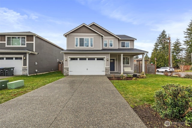 craftsman-style house with concrete driveway, a front yard, covered porch, stone siding, and an attached garage