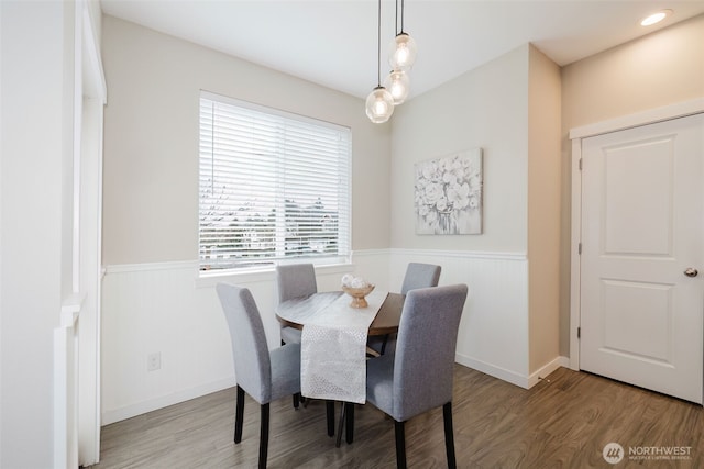 dining room with a wainscoted wall and wood finished floors