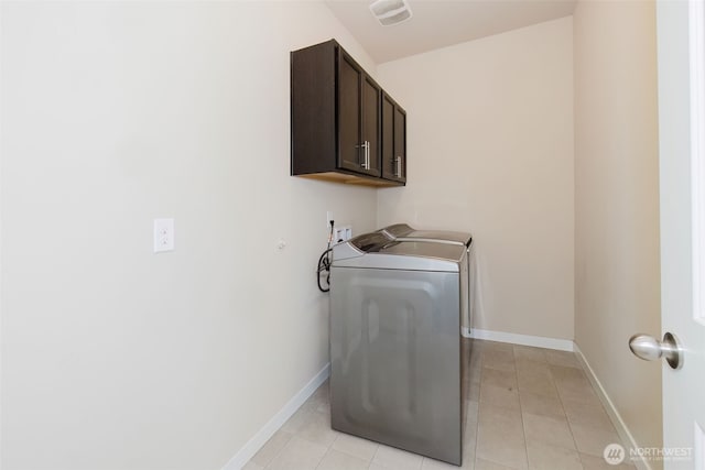 laundry area with visible vents, baseboards, light tile patterned flooring, cabinet space, and washer hookup