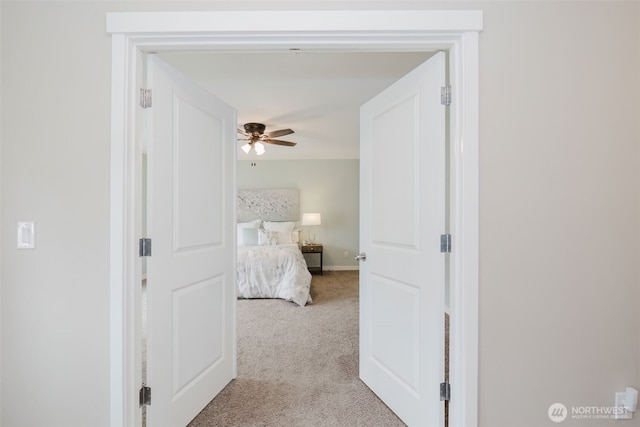 hall with carpet and baseboards