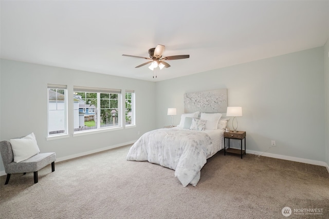 carpeted bedroom featuring a ceiling fan and baseboards