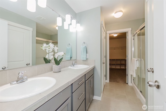 bathroom with a sink and a shower stall