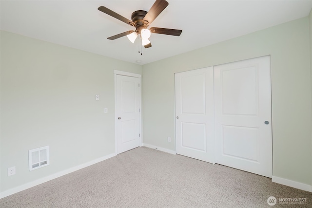 unfurnished bedroom with visible vents, baseboards, ceiling fan, light colored carpet, and a closet