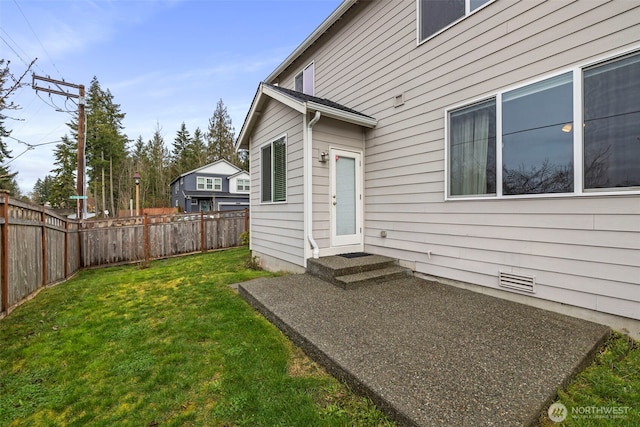entrance to property featuring a lawn, fence, and crawl space