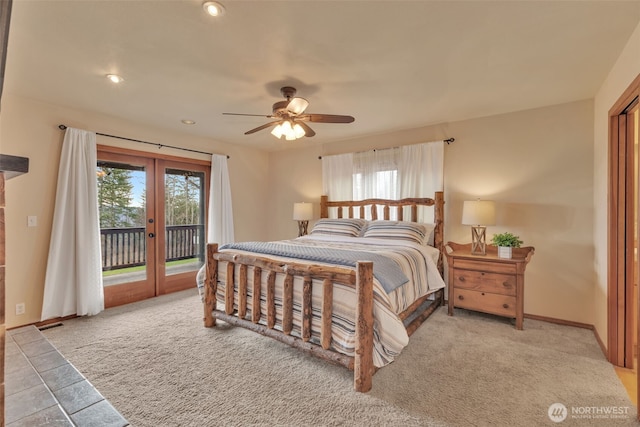 carpeted bedroom featuring baseboards, french doors, multiple windows, and access to exterior