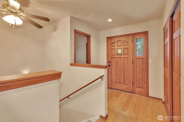 entryway featuring light wood-type flooring, ceiling fan, baseboards, and recessed lighting