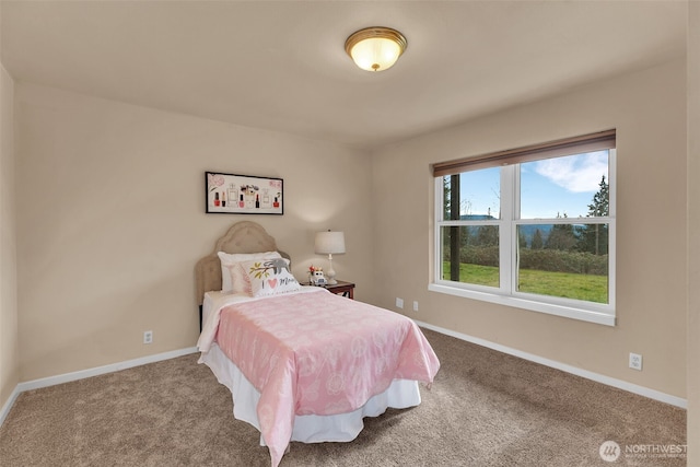 bedroom with carpet floors and baseboards